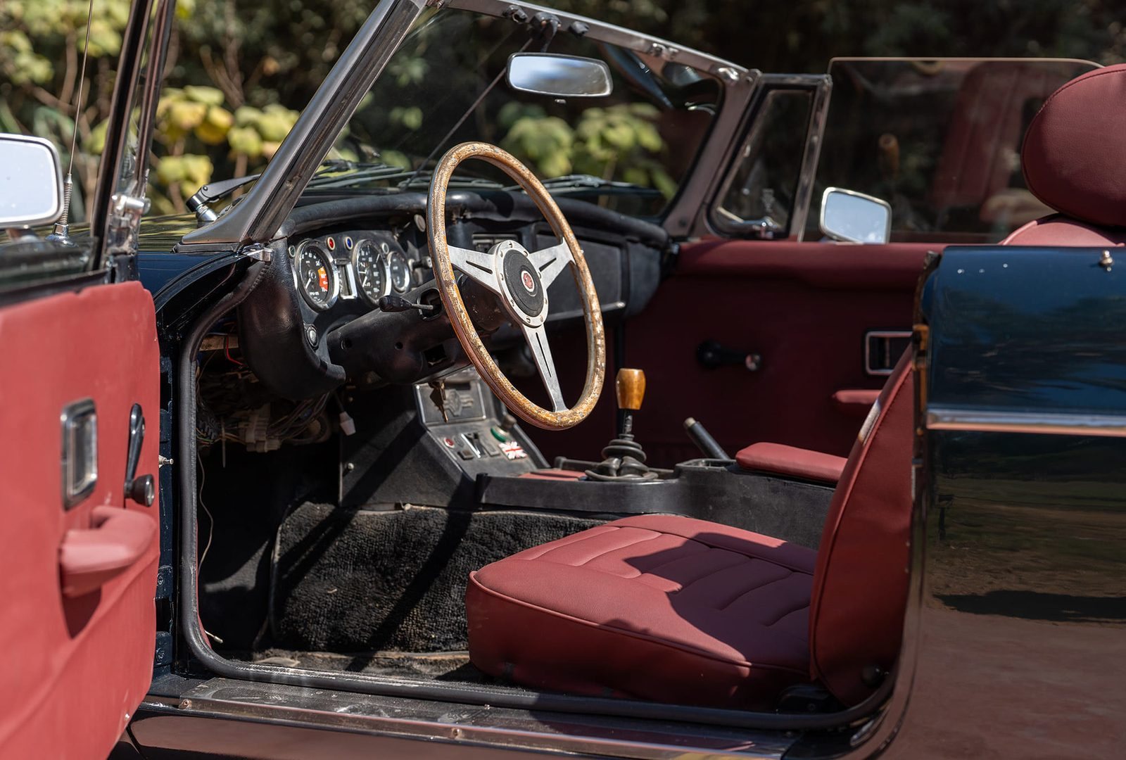 Habitacle bordeaux et volant en bois de la MGB
