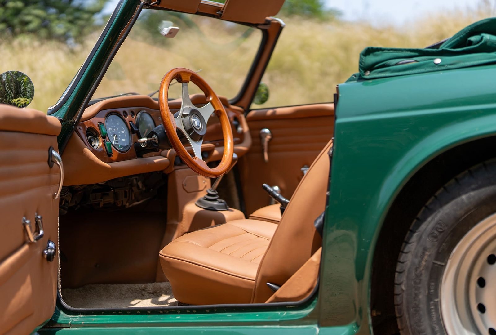 Volant en bois et portière ouverte de la Triumph TR6